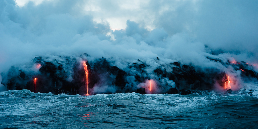 lava dripping off an edge into the ocean